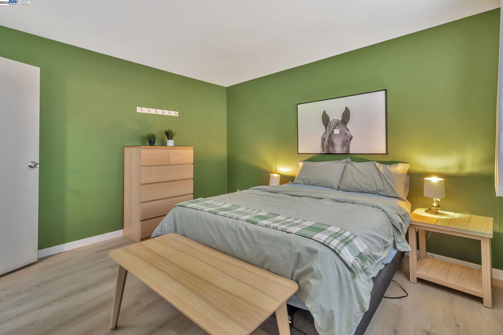 3877 Howe Street, Unit 106 Oakland, CA 94611 - Photo 13 of 17 a bedroom with a bed and a table