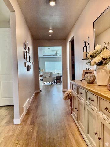 315 South Sherman Street Mapleton, UT 84664 - Photo 7 of 30 Hallway with wood-finish flooring, recessed lighting, and a console cabinet with multiple drawers and cabinet storage