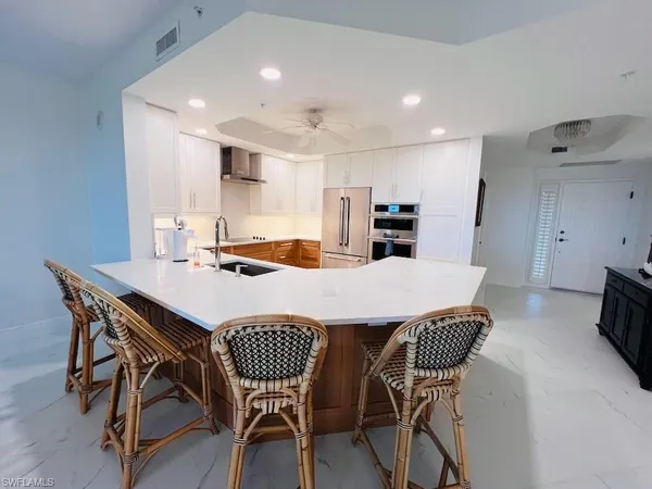 a outdoor kitchen with a table and chairs