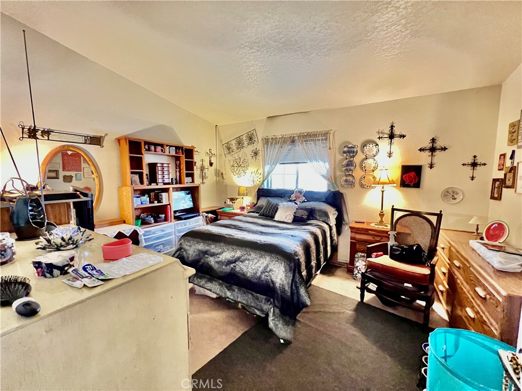 9391 California Avenue, Unit 97 Riverside, CA 92503 - Photo 16 of 21 a bedroom with a bed and a couch