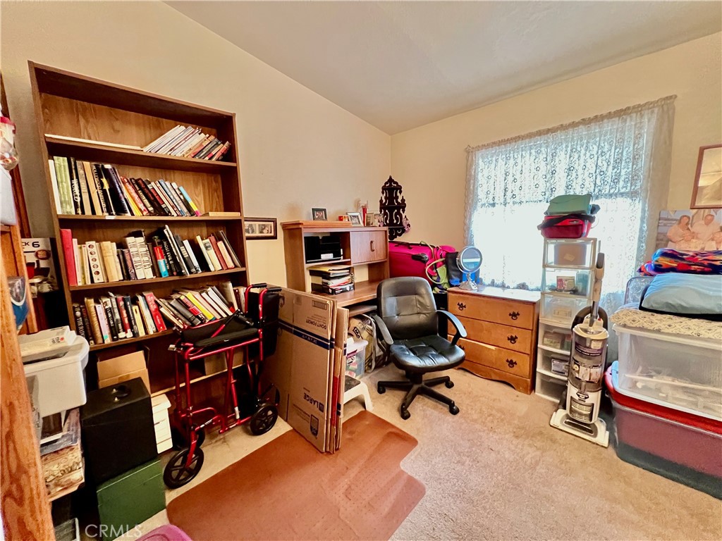 9391 California Avenue, Unit 97 Riverside, CA 92503 - Photo 17 of 21 a view of a workspace with furniture and a bookshelf