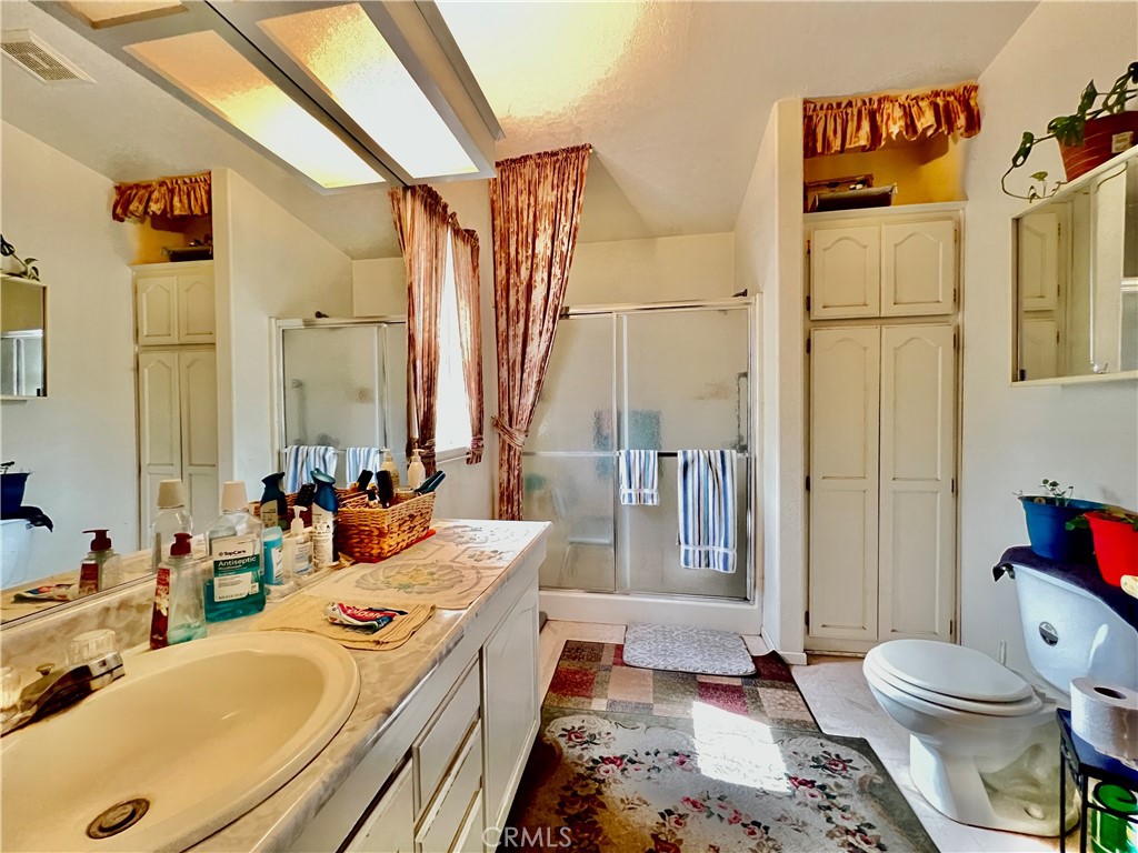 9391 California Avenue, Unit 97 Riverside, CA 92503 - Photo 19 of 21 a bathroom with a sink a toilet and shower