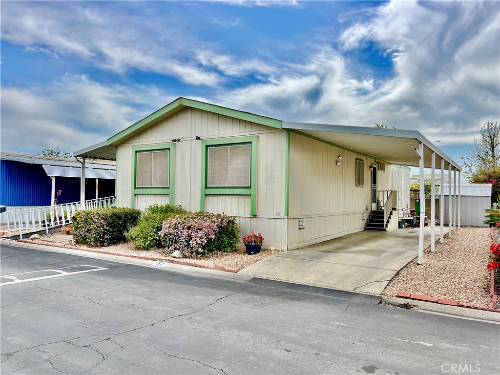 9391 California Avenue, Unit 97 Riverside, CA 92503 - Photo 3 of 21 a front view of a house with a yard
