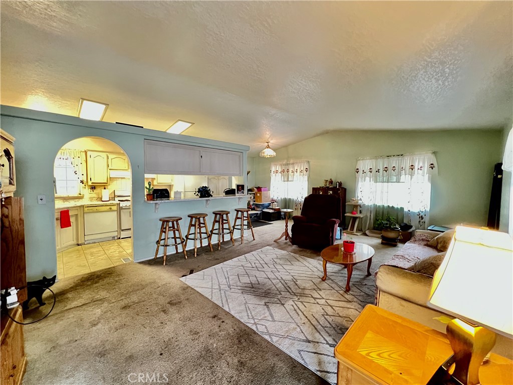 9391 California Avenue, Unit 97 Riverside, CA 92503 - Photo 5 of 21 a living room with furniture a rug and a flat screen tv