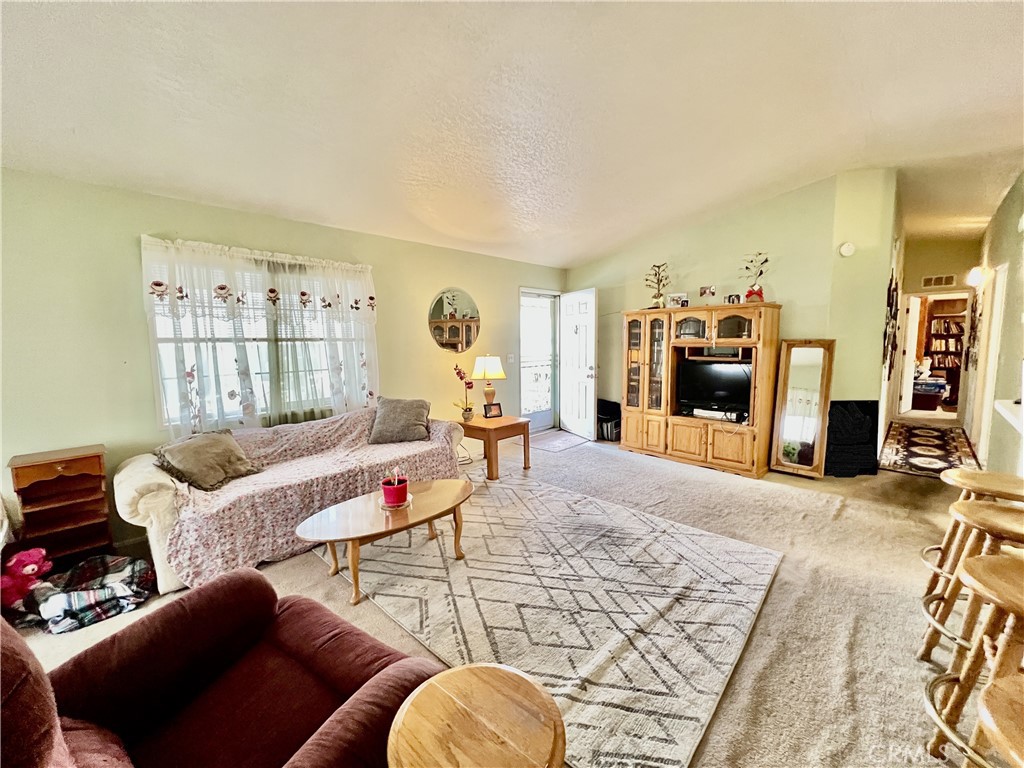 9391 California Avenue, Unit 97 Riverside, CA 92503 - Photo 6 of 21 a living room with furniture and a flat screen tv