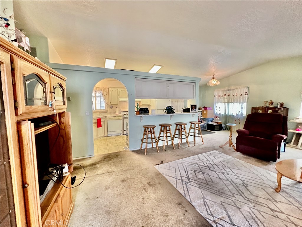 9391 California Avenue, Unit 97 Riverside, CA 92503 - Photo 7 of 21 a living room with furniture a couch and dresser with wooden floor