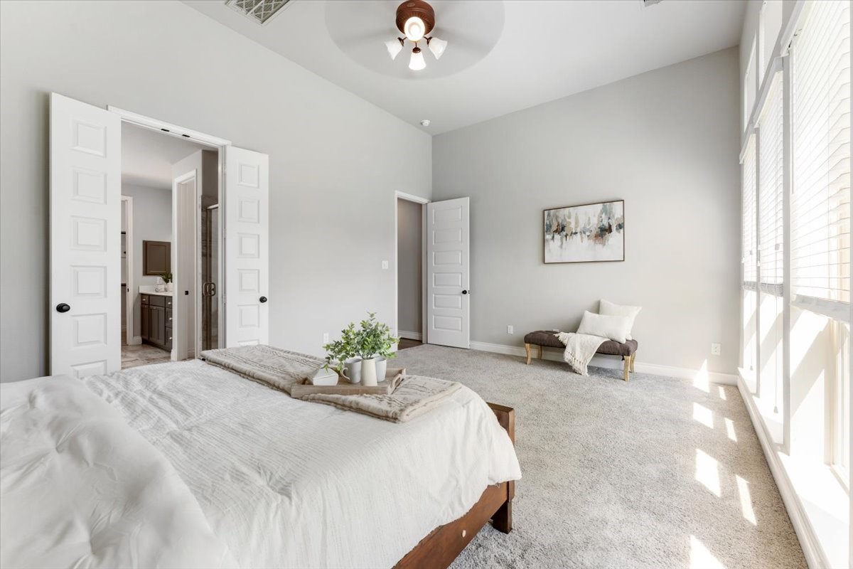 18843 Collins View Drive New Caney, TX 77357 - Photo 28 of 50 The floor to ceiling windows makes this primary bedroom light and bright with a great view of the backyard