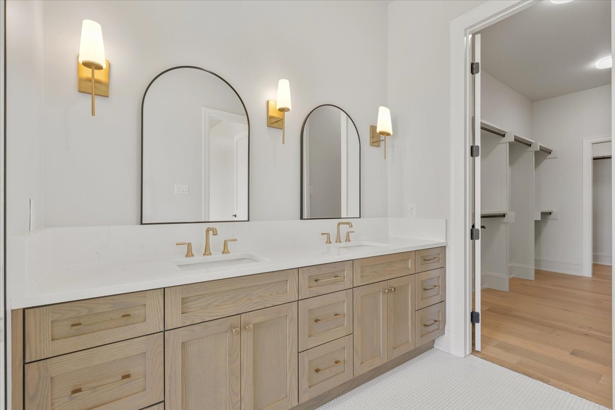 224 Sandia Loop Kingsland, TX 78639 - Photo 20 of 32 a bathroom with double vanity a sink a mirror and a shower