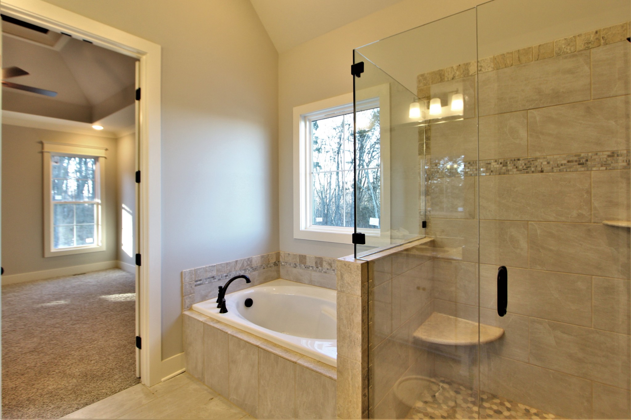 812 Ridgestone Place, Unit 103 Lebanon, TN 37087 - Photo 18 of 24 a bathroom with a tub a window and a shower