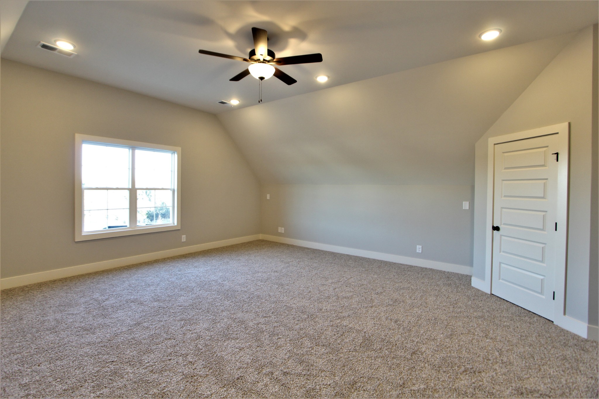 812 Ridgestone Place, Unit 103 Lebanon, TN 37087 - Photo 21 of 24 an empty room with a chandelier fan and windows