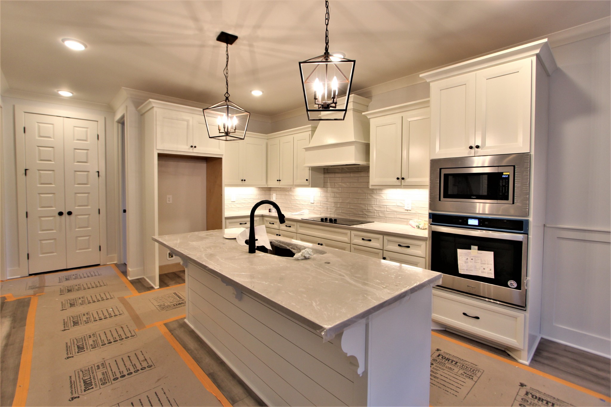 812 Ridgestone Place, Unit 103 Lebanon, TN 37087 - Photo 6 of 24 a kitchen with a sink stainless steel appliances and chandelier