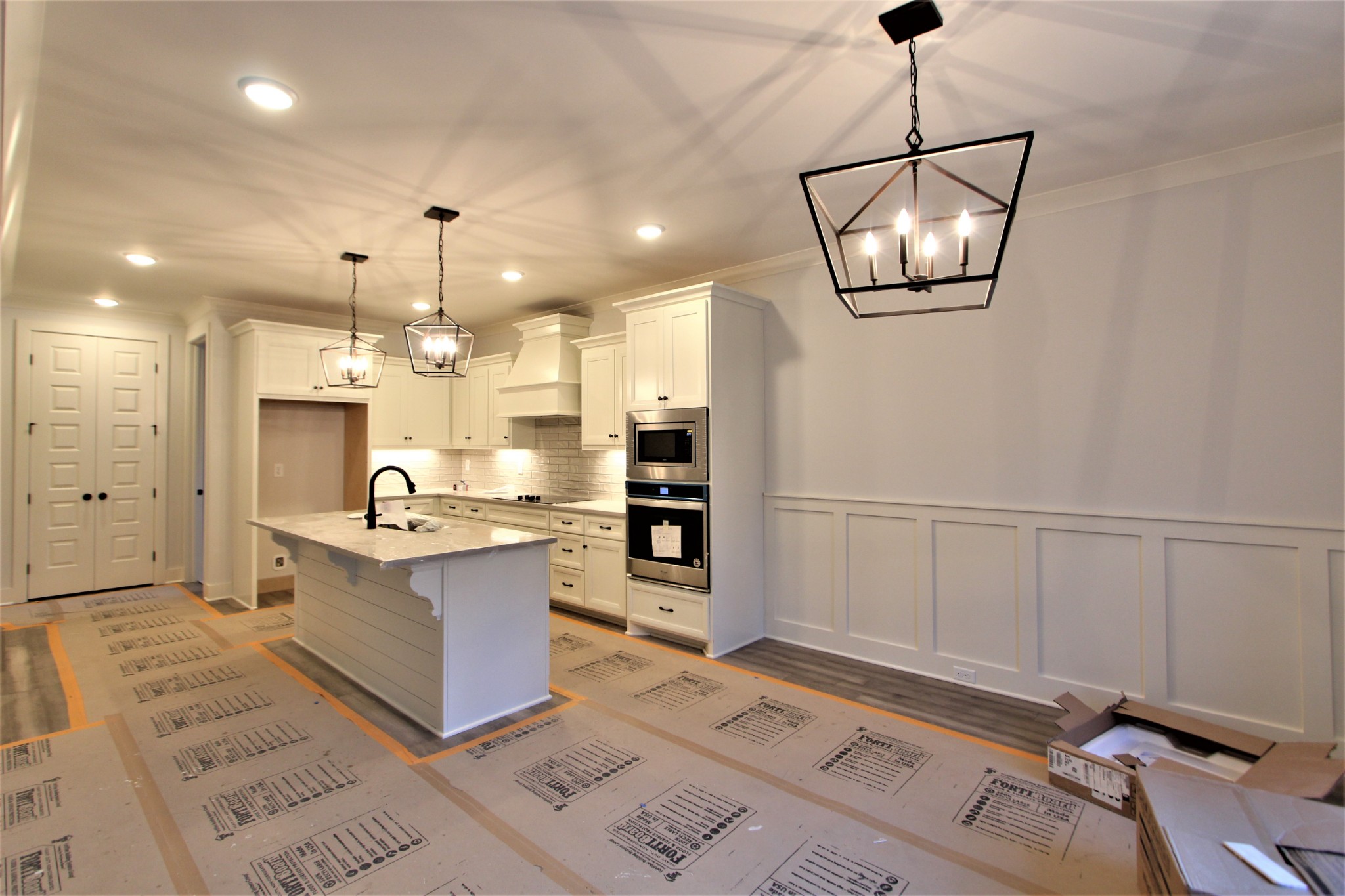 812 Ridgestone Place, Unit 103 Lebanon, TN 37087 - Photo 8 of 24 a large kitchen with kitchen island a sink stainless steel appliances and cabinets