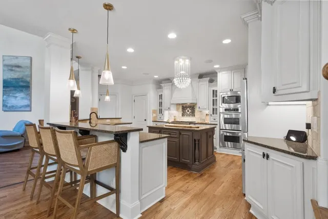 a kitchen with stainless steel appliances a stove sink microwave and cabinets