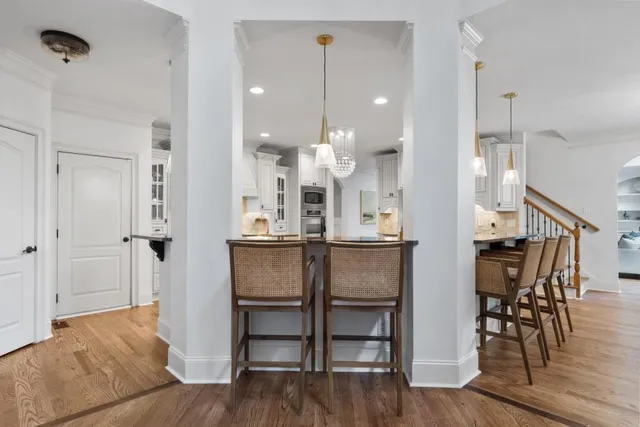 a kitchen with stainless steel appliances cabinets and a wooden floor