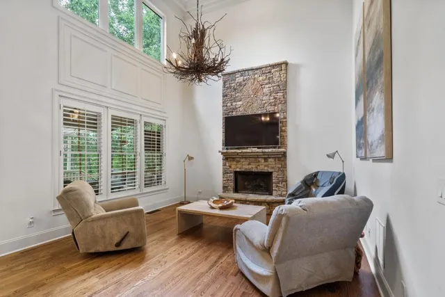 a spacious bathroom with a granite countertop sink a mirror and a shower