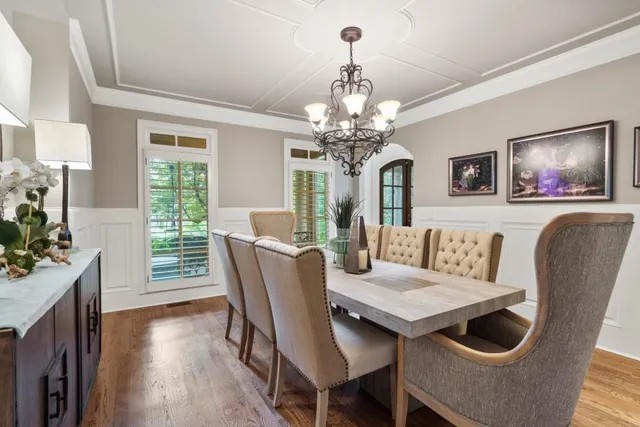 a dining room with furniture window and wooden floor