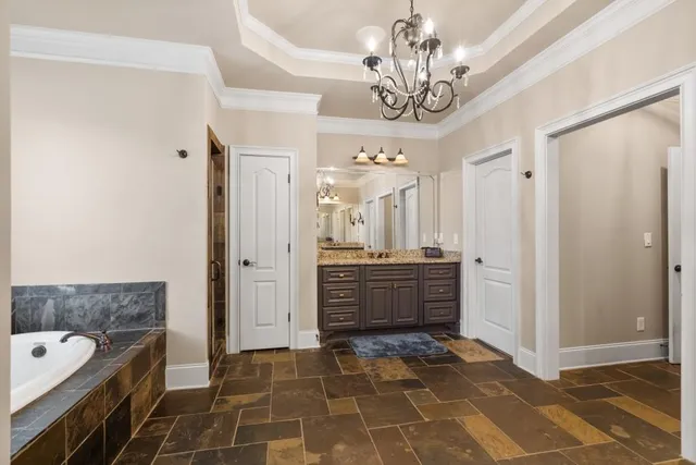 a bedroom with a bed and a flat tv screen on the dresser