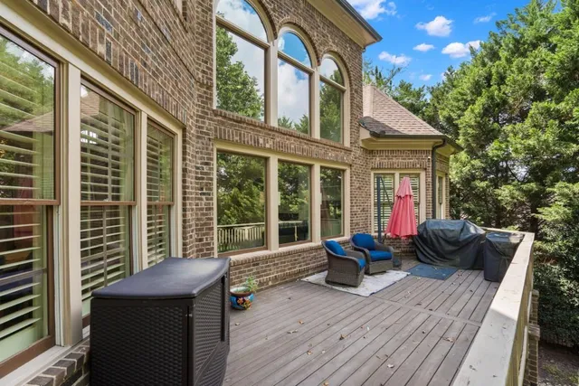 a view of empty room with window and ceiling fan