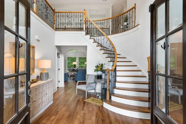 a living room with furniture a fireplace and a large window