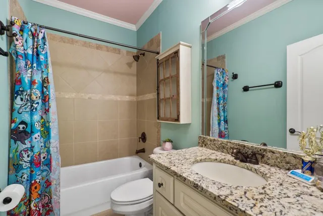 an aerial view of a house with a yard and garden