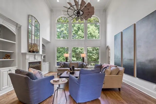 a kitchen with stainless steel appliances kitchen island granite countertop a sink a stove a dining table and chairs