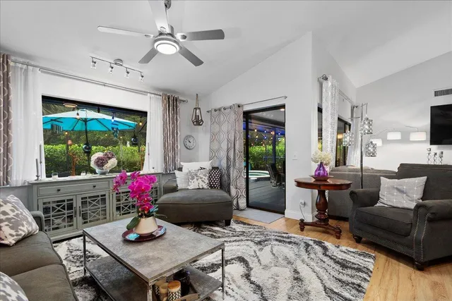 a living room with furniture and a floor to ceiling window