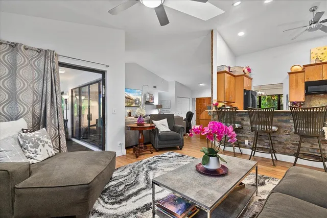 a living room with furniture and flowers