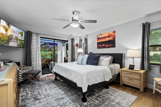 a bedroom with a bed and a large window