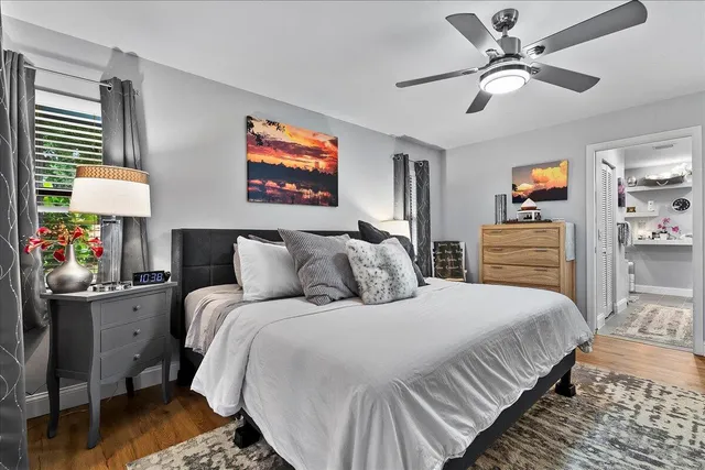 a bedroom with bed and a chandelier