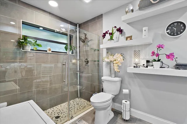 a bathroom with a sink toilet and shower