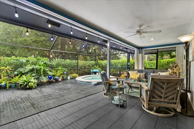 a living room with patio furniture and garden