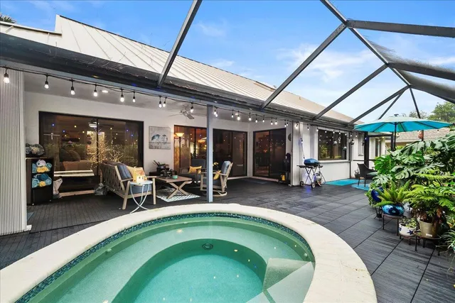 a swimming pool with outdoor seating and patio