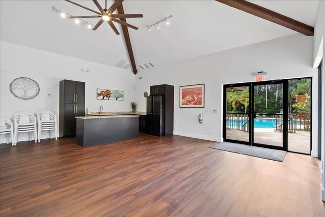 a view of a kitchen with wooden floor and electronic appliances