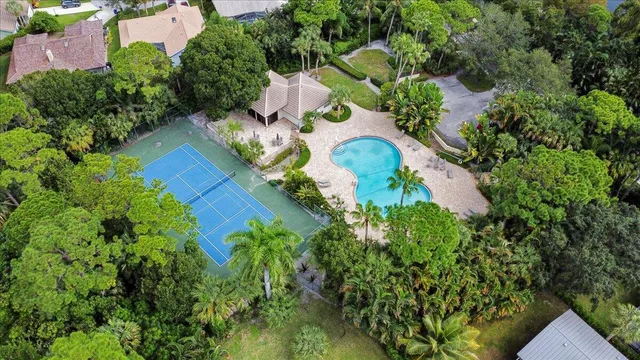 an aerial view of house with yard swimming pool and outdoor seating
