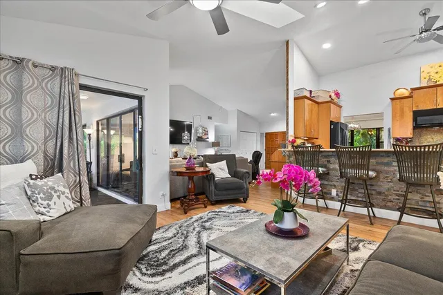 a living room with furniture and flowers