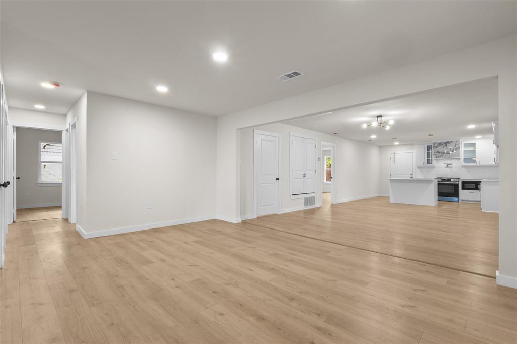 907 Pinson Road Forney, TX 75126 - Photo 6 of 35 Expansive open-concept living area featuring light wood-finish flooring, recessed lighting, and a neutral color palette