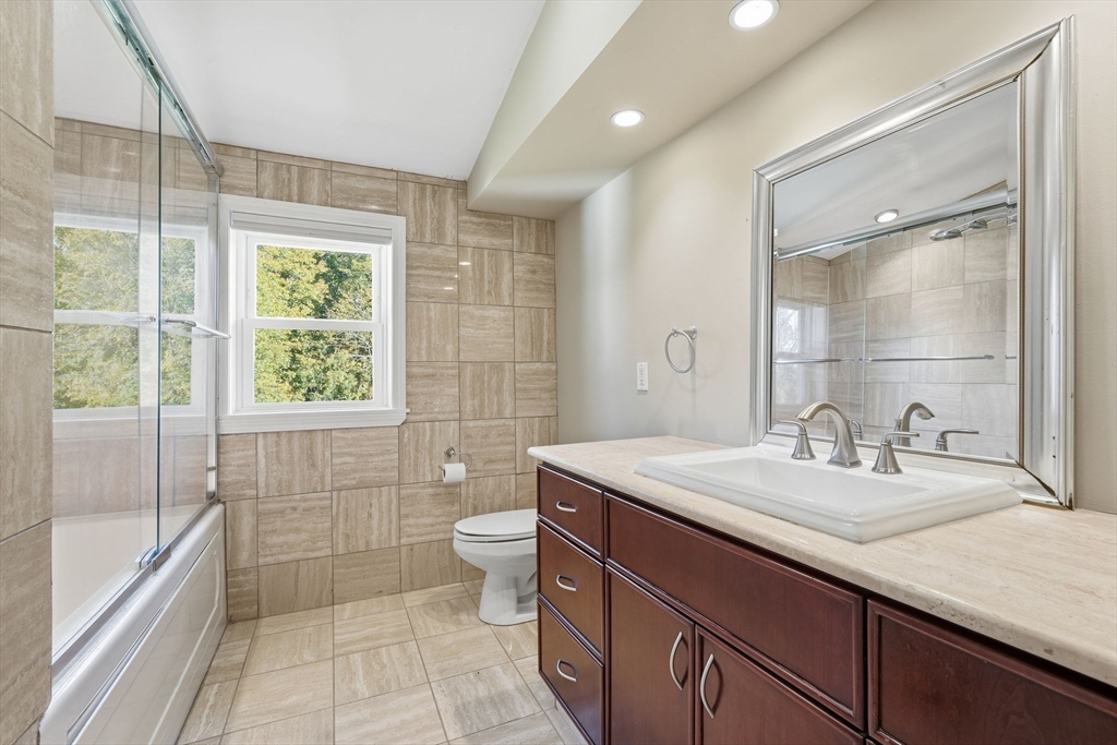 50 Overlook Drive West Springfield, MA 01089 - Photo 21 of 28 a bathroom with a granite countertop sink a toilet a mirror and shower