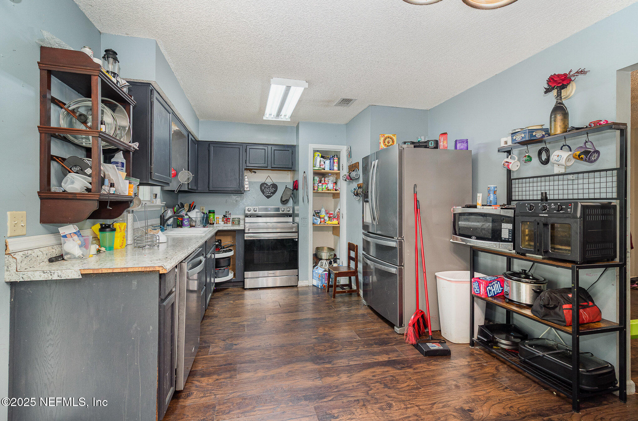 104 East Oakside Drive Interlachen, FL 32148 - Photo 13 of 26 a view of a kitchen with fridge and workspace