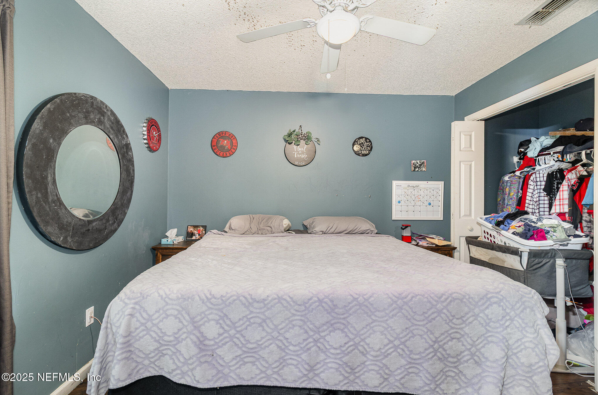 104 East Oakside Drive Interlachen, FL 32148 - Photo 16 of 26 a bedroom with a bed and a chandelier