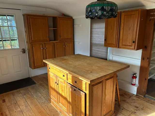 a kitchen with a stove and a wooden floor