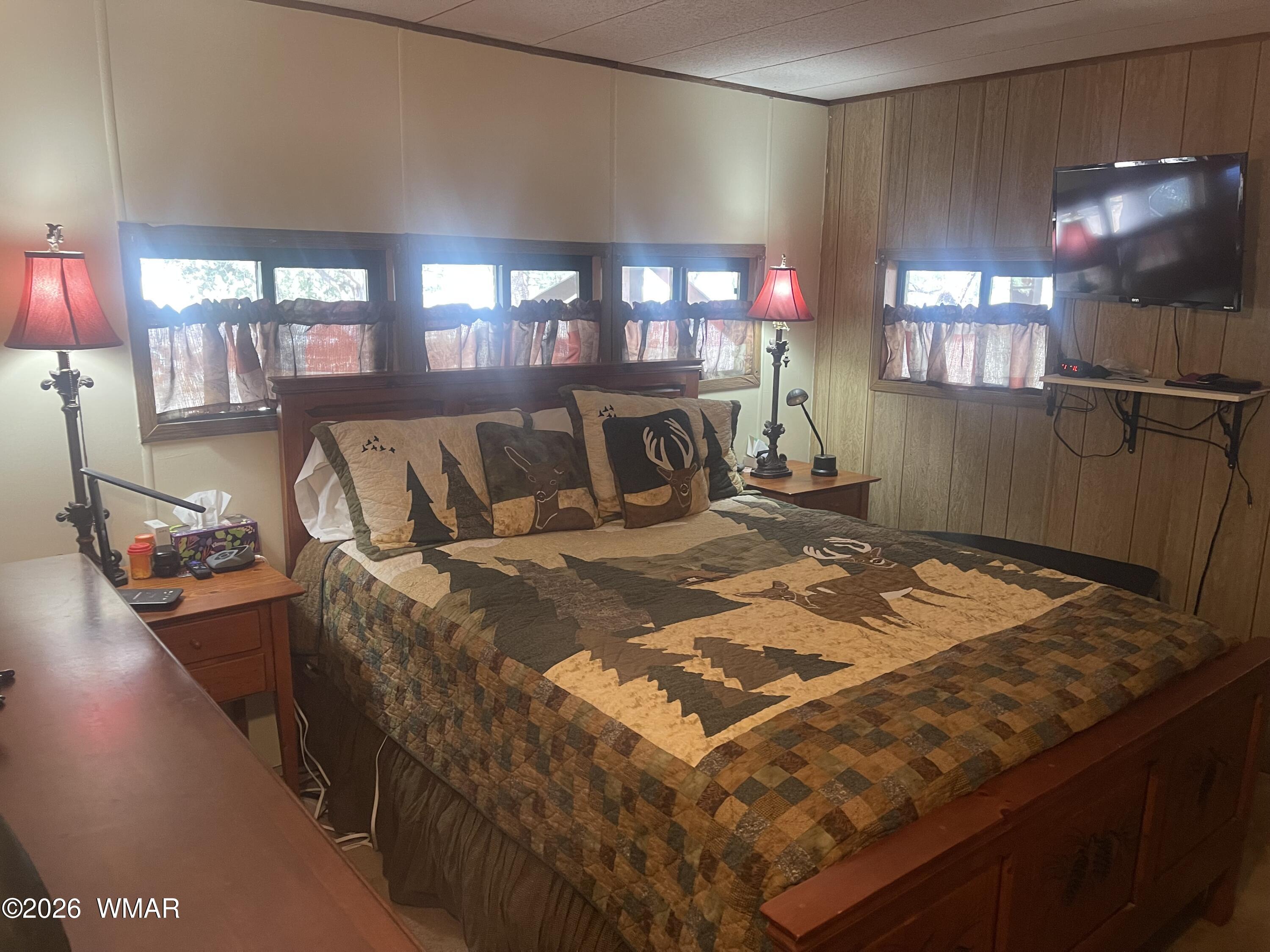 2871 Moose Trail Overgaard, AZ 85933 - Photo 12 of 25 a bed sitting in a bedroom next to a window