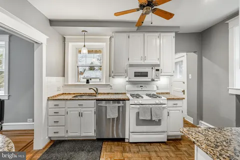 a kitchen with cabinets appliances and a window