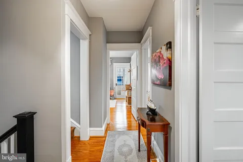 a view of a hallway with paintings on the wall