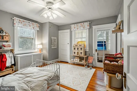 a bedroom with a bed and glass walk in closet