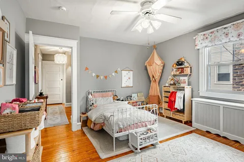 a bedroom with bed and a chandelier