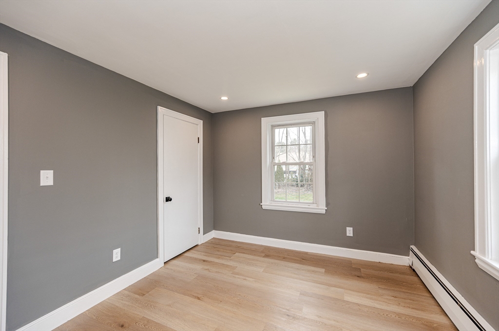 12 Pichowicz Road Billerica, MA 01821 - Photo 14 of 31 a view of an empty room with wooden floor and a window