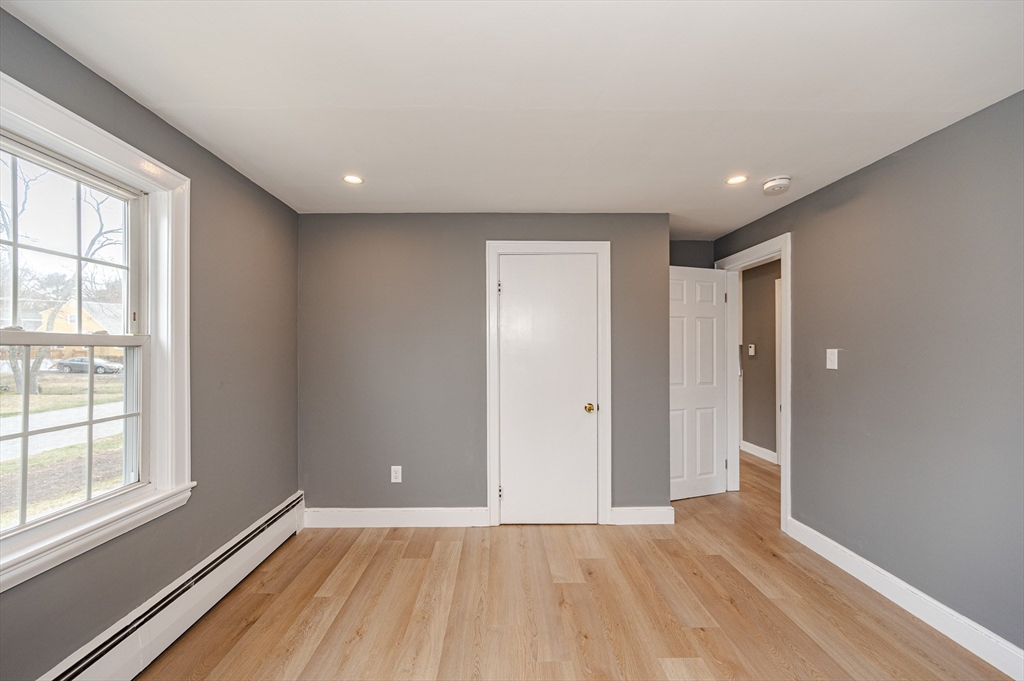 12 Pichowicz Road Billerica, MA 01821 - Photo 18 of 31 a view of an empty room with wooden floor and a window