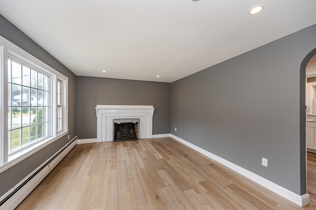 12 Pichowicz Road Billerica, MA 01821 - Photo 4 of 31 wooden floor fireplace and windows in an empty room
