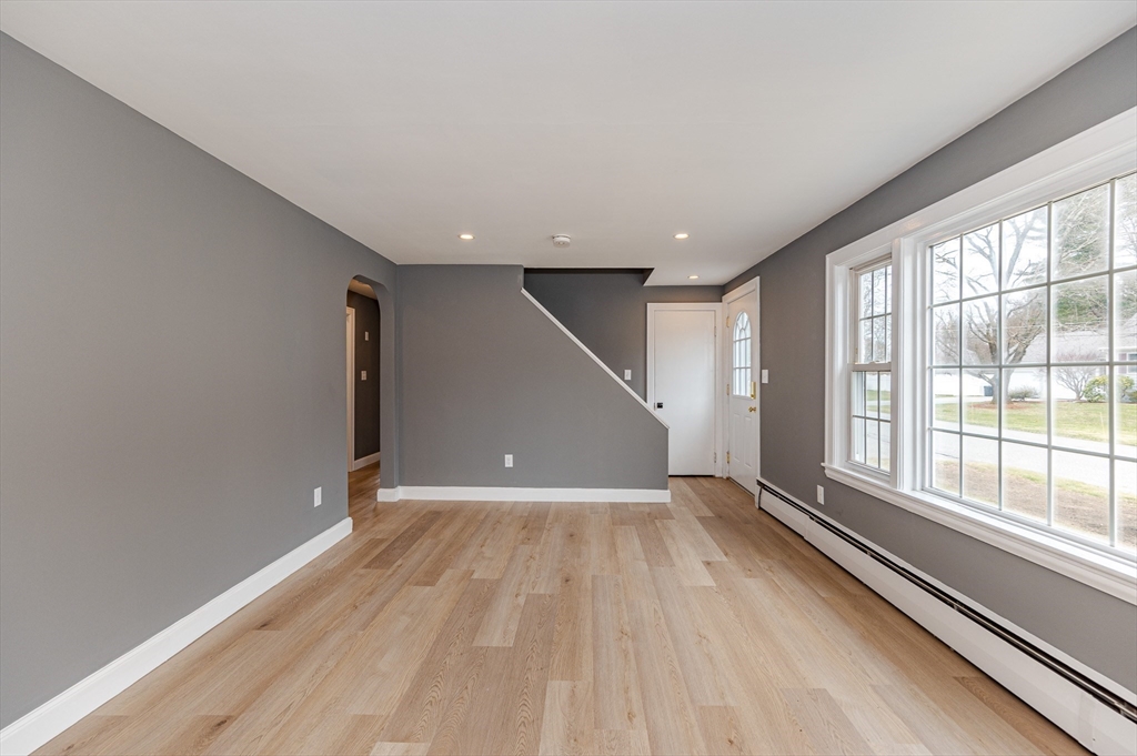 12 Pichowicz Road Billerica, MA 01821 - Photo 6 of 31 wooden floor in an empty room with a window