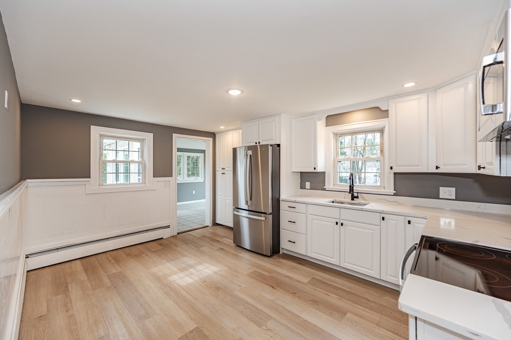 12 Pichowicz Road Billerica, MA 01821 - Photo 7 of 31 a kitchen with a refrigerator and wooden cabinets